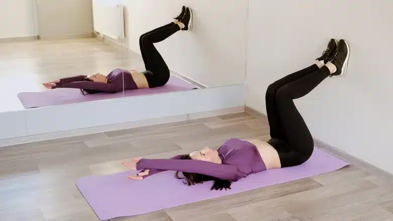 Your Guide To Wall Pilates For An Effective At-Home Workout